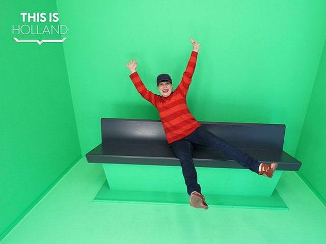 Picture of Agnès Bompy on a couch in front of a green wall